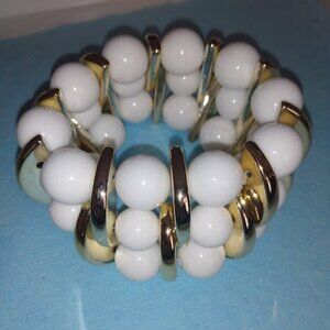 Multi layered gold tone and white beaded bracelet.